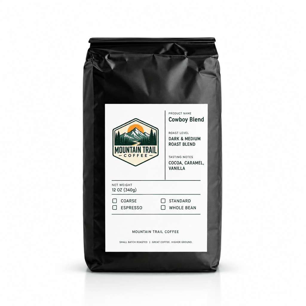 Coffee bag, Cowboy Blend in matte black packaging with a white label and mountain trail logo, featuring dark and medium roast details.